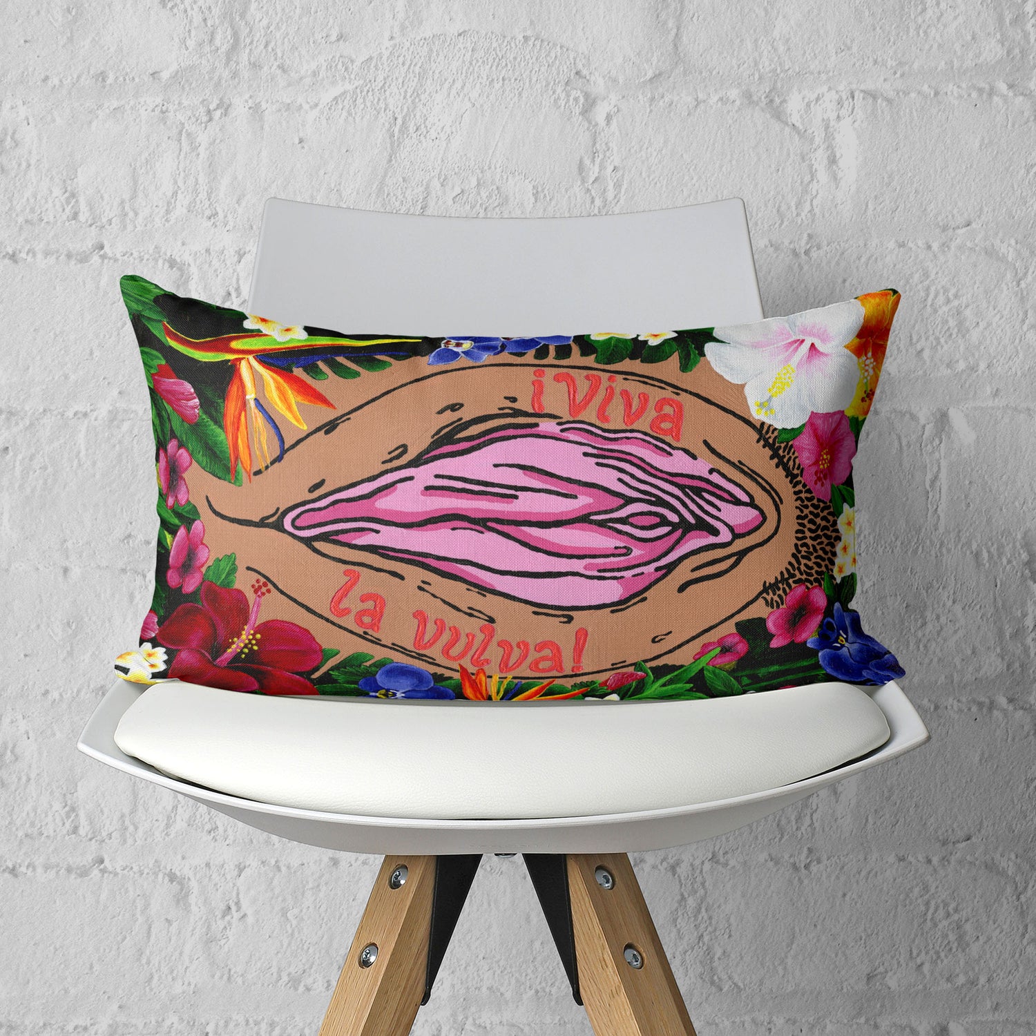 Throw pillow featuring a vulva surrounded by flowers and the text, 'Viva La Vulva'.