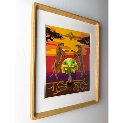 A framed art print featuring two lions either side of a Venus flytrap against a sunset sky, mounted in a light wood frame with a white mat on a light gray wall.