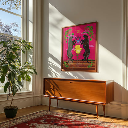 Framed giclée print of the black panthers and yellow iris art mounted on a white wall above a wooden mid-century modern credenza, in a brightly lit room next to a large window and houseplant.