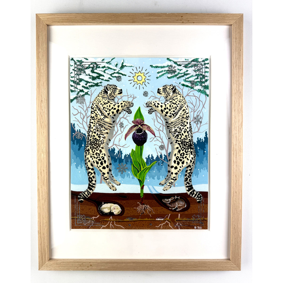 Straight-on view of a framed artwork featuring two snow leopards rearing symmetrically on either side of a central orchid in a snowy winter landscape, housed inside a light oak wood frame with a white window mat.