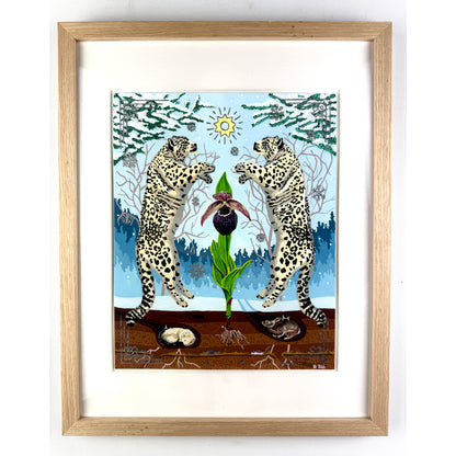 Straight-on view of a framed artwork featuring two snow leopards rearing symmetrically on either side of a central orchid in a snowy winter landscape, housed inside a light oak wood frame with a white window mat.