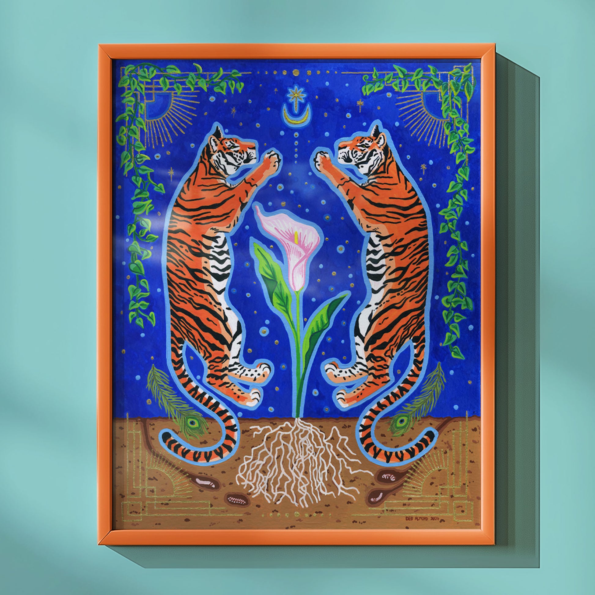 Framed giclée print of the tiger and calla lily artwork displayed in a warm orange-brown wood frame against a light aqua wall.