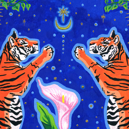Close-up detail of the giclée print highlighting the upper half of the composition, showing the heads and raised paws of the two tigers, the delicate top of the calla lily, and the gold star and moon motifs surrounded by gold specks against a rich blue backdrop.