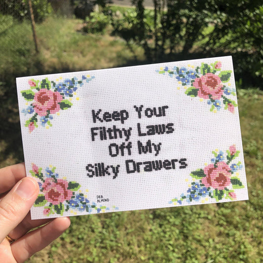 Greeting card with floral cross-stitch reading: Keep Your Filthy Laws Off My Silky Drawers. By Deb Almond Art.